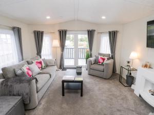 a living room with two couches and a table at Lazy Daze in Bridlington