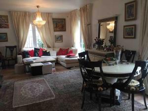 een woonkamer met een tafel en een bank bij Villa Bonaparte in Touques