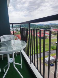 a balcony with a table and a view of a field at Heritage Homestay in Kota Tinggi