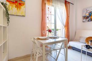 sala de estar con mesa y sofá en Acogedor y céntrico apartamento, en Málaga