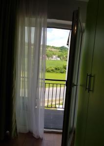 a room with a window with a view of a field at Apartament 3 Budiu in Târgu-Mureş +1 photo