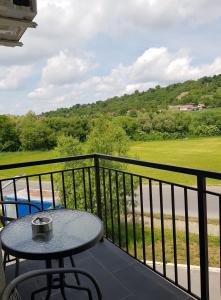 a table on a balcony with a view of a golf course at Apartament 7 Budiu in Târgu-Mureş