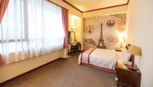 Postel nebo postele na pokoji v ubytování East Commercial Affairs Hotel