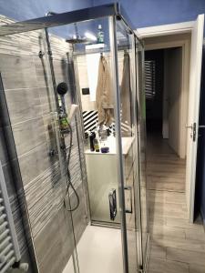 a walk in shower with a glass door in a room at Casa Vacanze al mare in Pescara