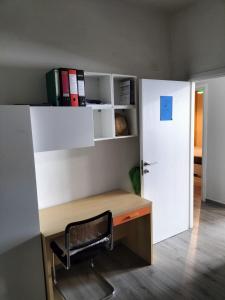 a office with a desk and a chair next to a door at Casa Vacanze al mare in Pescara