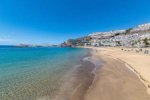 a view of a beach with the ocean and buildings at Punta Del Rey Only Adults in Puerto Rico de Gran Canaria