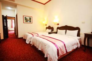Postel nebo postele na pokoji v ubytování East Commercial Affairs Hotel