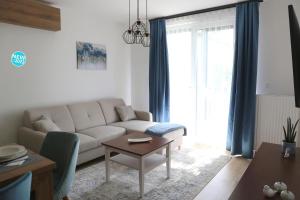 a living room with a couch and a table at St.Gotthard Apartman in Szentgotthárd