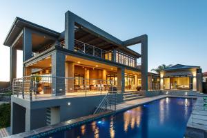 a house with a swimming pool in front of a house at Sonas Boutique Hotel in Oudtshoorn