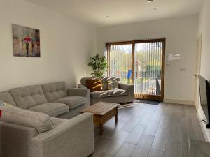 a living room with a couch and a table at Apt 4 - Silver Spruce in Killarney