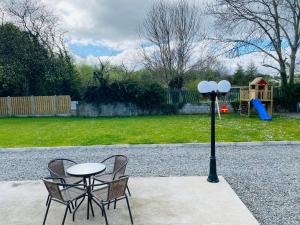 a table and two chairs and a light pole at Apt 4 - Silver Spruce in Killarney