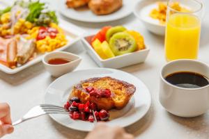 a table with plates of food and a plate of food at Shin Osaka Esaka Tokyu REI Hotel in Suita