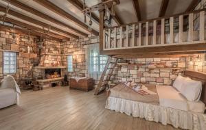 a bedroom with a bunk bed and a ladder at Emilia's Little Farmhouses in Agii Anargiri Milos