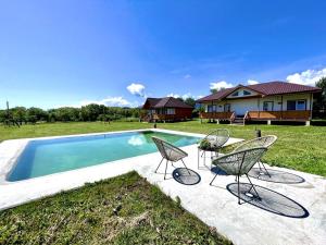 a group of chairs sitting next to a swimming pool at Agapia Agapescu in Agapia