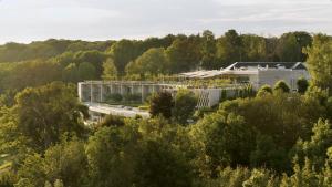 an aerial view of a building in the forest at Royal Champagne Hotel & Spa in Champillon