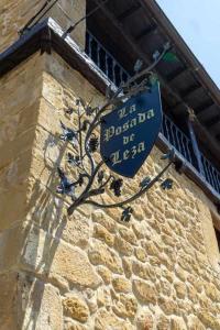 a blue sign on the side of a building at La Posada de Leza Your wine country getaway in Laguardia