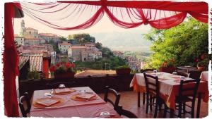 a restaurant with tables and chairs with a view at Hotel Ristorante El Caracol in Mulazzo