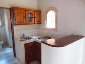 a kitchen with a sink and a counter top at SNI-Village Ambohidratrimo au bord du Lac Andranotapahana in Ambohidratrimo