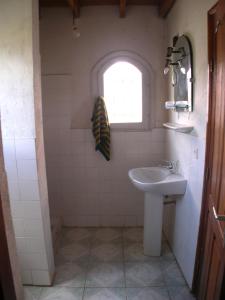 a bathroom with a sink and a window at SNI-Village Ambohidratrimo au bord du Lac Andranotapahana in Ambohidratrimo +11 photos