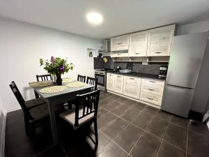 a kitchen with a table and a refrigerator at Flore's Garden Glamping in Bran