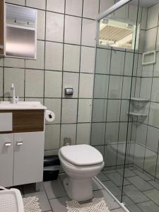 a bathroom with a toilet and a sink and a shower at Casa da Vila in Porto Belo