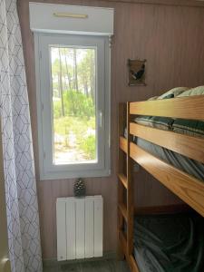 a bedroom with a bunk bed and a window at Chalet Mavalear naturiste La Jenny in Le Porge +20 photos