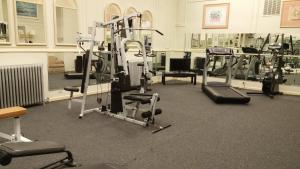 a gym with several tread machines in a room at Hotel Riviera in Newark