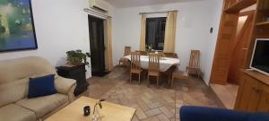 a living room with a table and a dining room at Kuća za odmor Silver pine in Ogulin