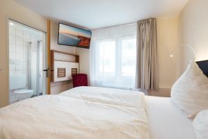 Säng eller sängar i ett rum på Hotel Helgolandia