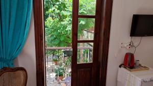 a room with a door and a window with plants at Sibel Hotel in Antalya