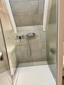 a shower with a glass door in a bathroom at Olive Bed and Breakfast in Amsterdam