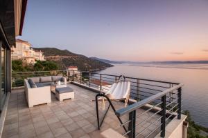 a balcony with a view of the water at Sea Whisper Villa in Peloponnese in rkadiko Chorio
