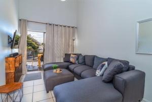 a living room with a couch and a table at Cozy All-in-One Ocean View Apartment in Kingsburgh