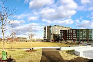 a park with two buildings and a large field at Luxury Executive Suite Harvard Allston 3 Bedrooms 2 Baths in Boston