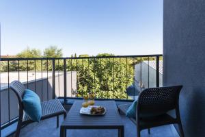 a table with a plate of food on a balcony at Modern 3-bedroom villa with a private pool in Pula