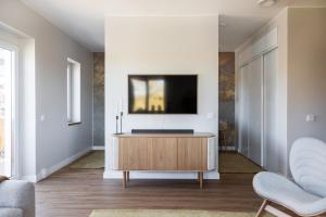 a living room with a tv on a wall at Bucco Suites in Pori