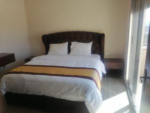 Una cama o camas en una habitación de Al-Ahlam Hotel Apartments