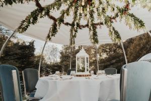 a table in a marquee with a lantern at Mercure Gloucester Bowden Hall Hotel in Gloucester