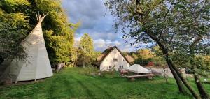 a large white house with a tent in the yard at Apartment Vera, Nähe Binz in traumhafter Alleinlage, 4-8 P. in Zirkow