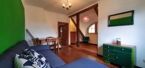 a living room with a blue couch and a table at Apartment Vera, Nähe Binz in traumhafter Alleinlage, 4-8 P. in Zirkow