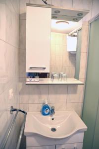 a bathroom with a sink and a white cabinet at Apartment Anamarija Valun in Valun