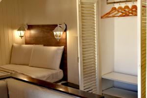 a small bedroom with a bed and a closet at Tiny Circe house - alloggio turistico in San Felice Circeo