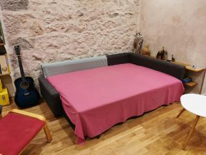 um quarto com um sofá com um cobertor rosa em Our home, Cozy Apartment two minutes from the sea - Clima em Nice