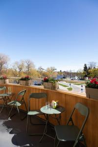 a row of tables and chairs on a balcony with a view at Bucco Suites in Pori