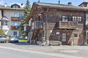 an old wooden building with a wooden staircase on it at Orsa Maggiore in Livigno