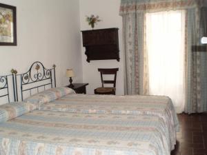 Postel nebo postele na pokoji v ubytování Hostal Gran Capitan