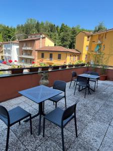 a group of tables and chairs on a patio at Hotel degli Dei in Pianoro