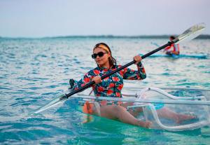 a woman in a kayak in the water at Las Fridas in Bacalar