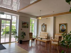 a living room with a table and chairs at Hotel Jurate in Nida