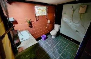 a bathroom with a sink and a shower and a toilet at Leaf House Bungalows in Ko Lanta